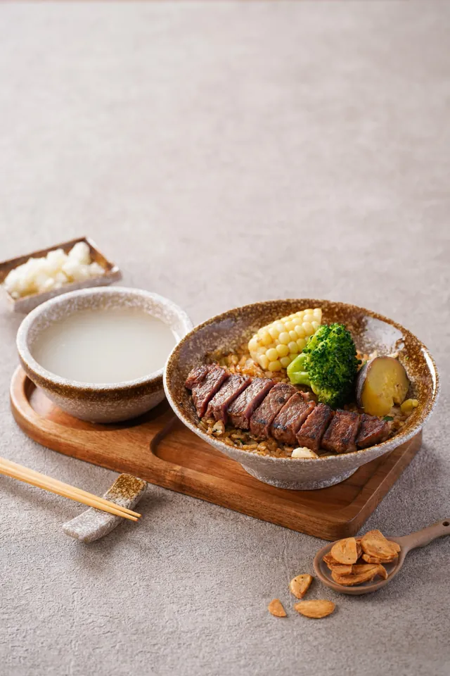 Sliced steak over egg fried rice, with corn and broccoli